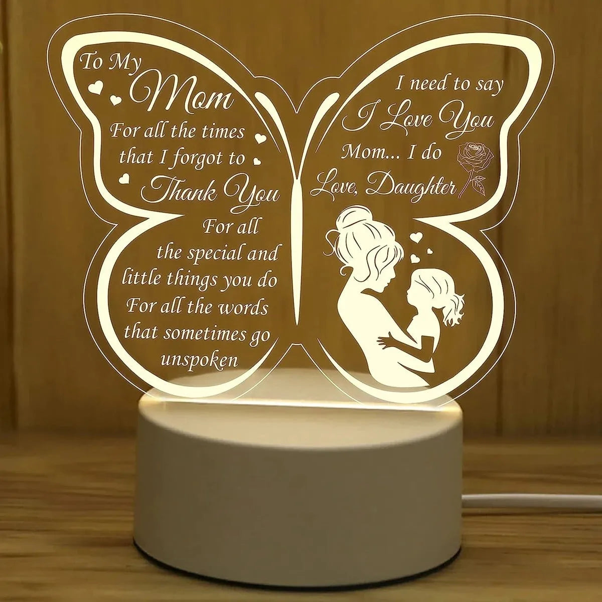 White heart-shaped acrylic table lamp with USB cable and touch control on a wooden surface