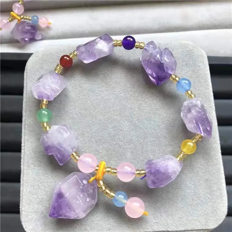 Natural shaped purple amethyst bead bracelet for women with a fu charm.