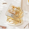 Clear and amber gold rotating plastic cosmetics storage box on a vanity.