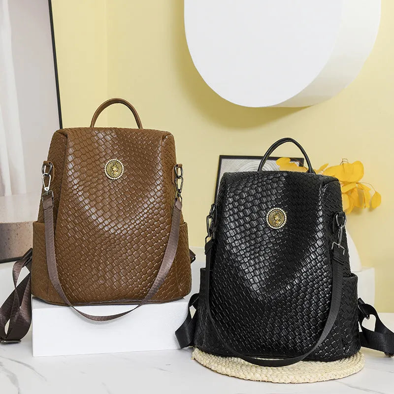 Women's black anti-theft backpack with weaving detail and organisational compartments