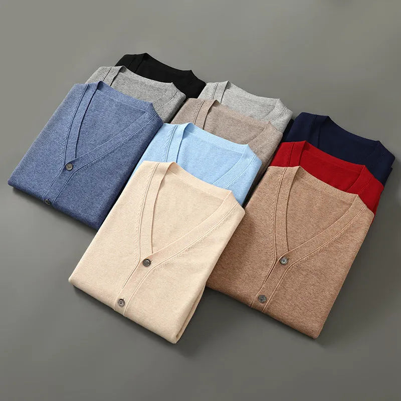 Man wearing a loose beige Andy Velvet V-neck cardigan coat with long sleeves.