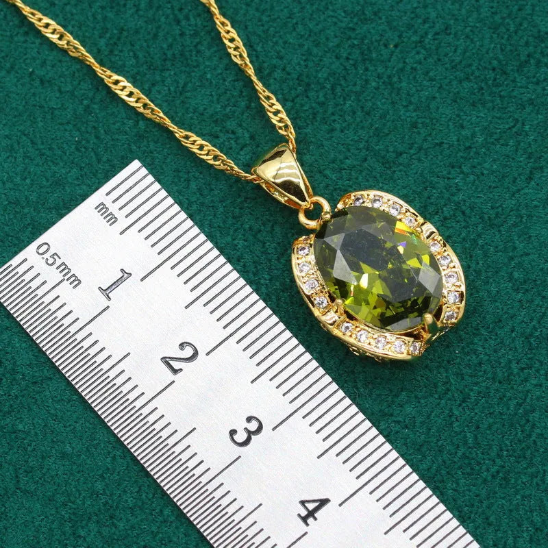 Olive green zircon rhinestone jewellery set on snake bone chain with crown pendant, plus matching earrings and ring.