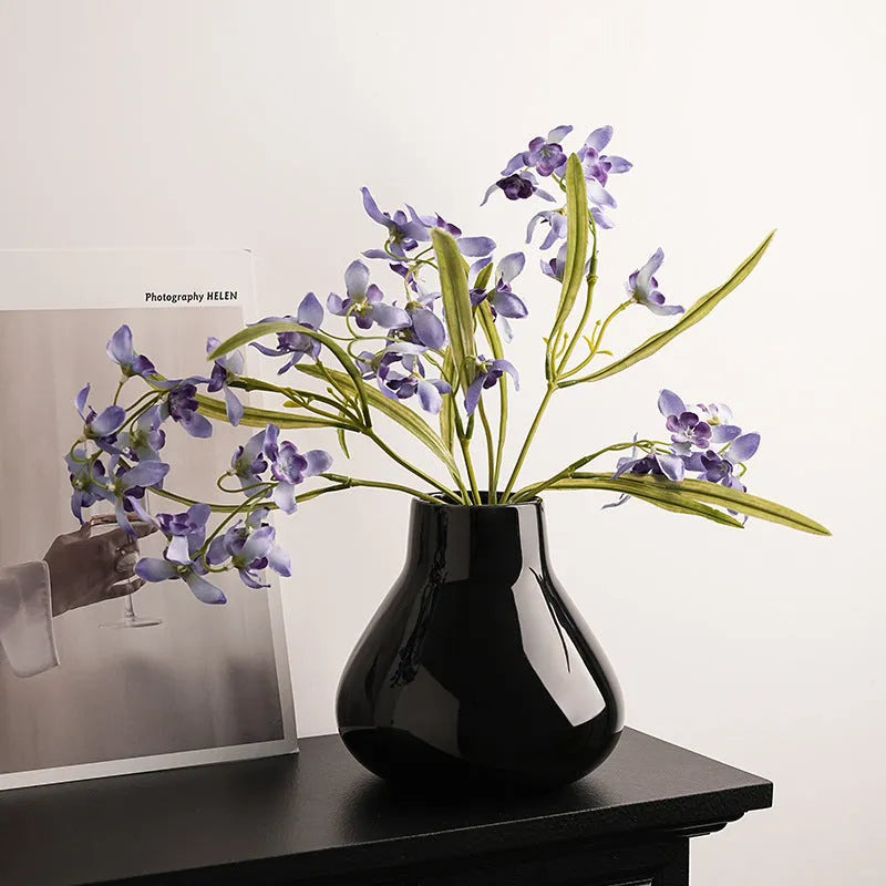Ceramic decorative vase with artificial orchid flowers in black or white colour options