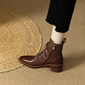 Black women's pointed-toe ankle boots with a PU upper and a 5.5cm heel on a plain background.