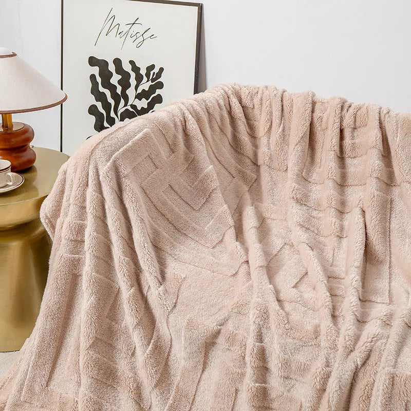 Thick coral fleece flannel blanket folded, showing solid green colour and soft texture.