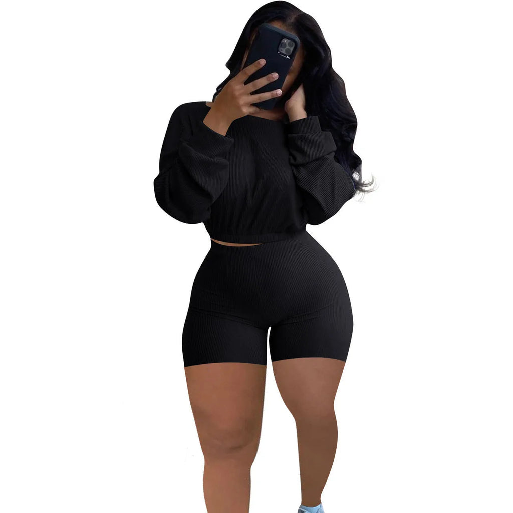 Women's off-the-shoulder long sleeve top and shorts two-piece set in a solid colour.