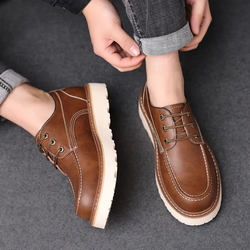 Men's black Martin boots with low-top retro design showing rubber sole and round toe shape