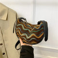 Women's woven straw crossbody bag with single strap and internal phone pocket