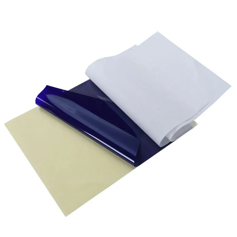 Stack of A4 tattoo transfer paper sheets with clear quadruple lines and transfer gel tube