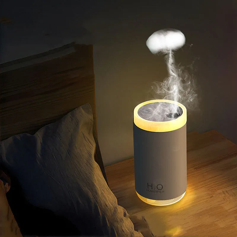 White jellyfish-themed USB humidifier with warm night light on a wooden table.