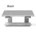 Black aluminium alloy laptop stand folded on desk next to silver version