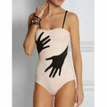 Women's one-piece swimsuit bikini with a sheer gauze skirt overlay.