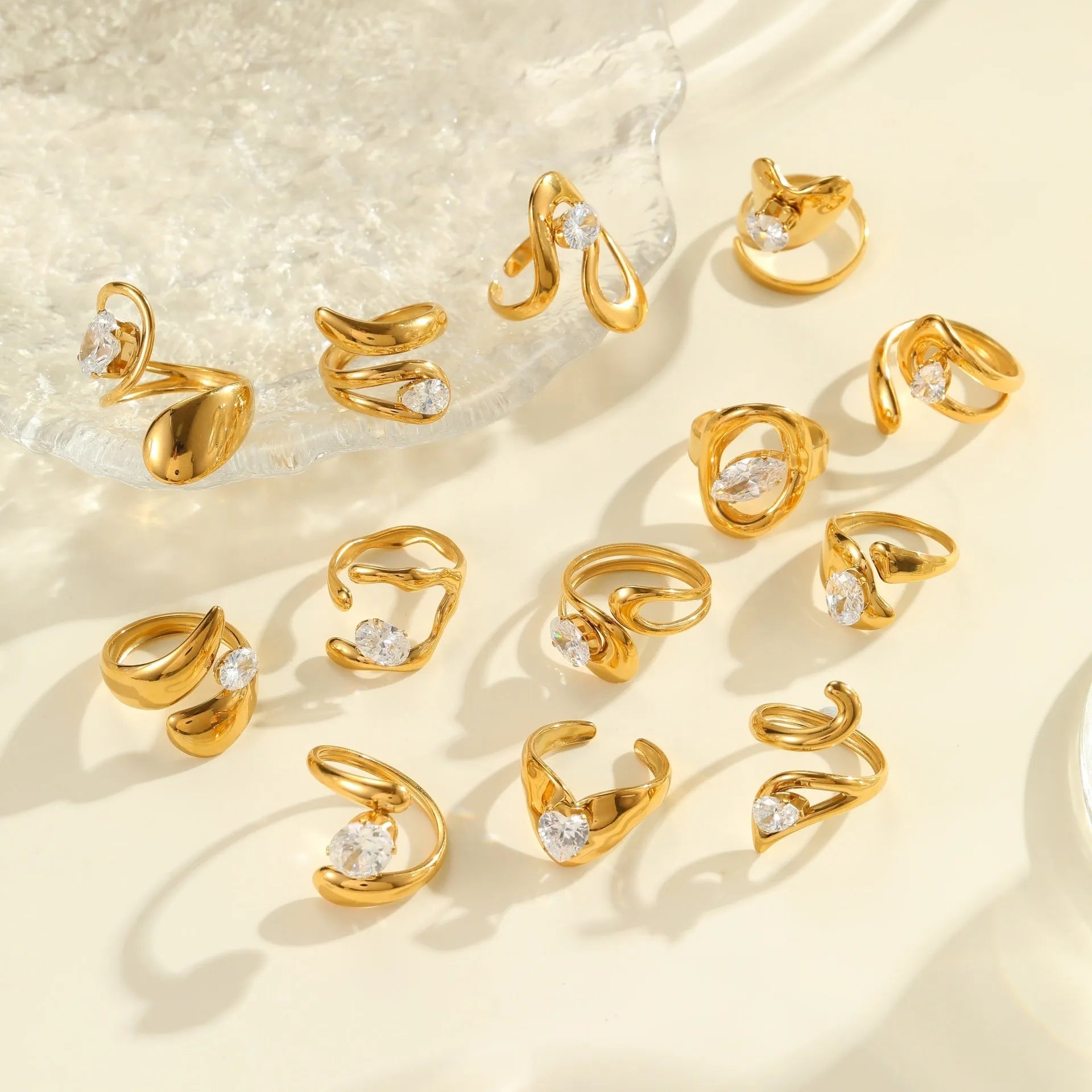 Open mouth geometric zircon ring with round, oval and quadrangle elements on stainless steel band