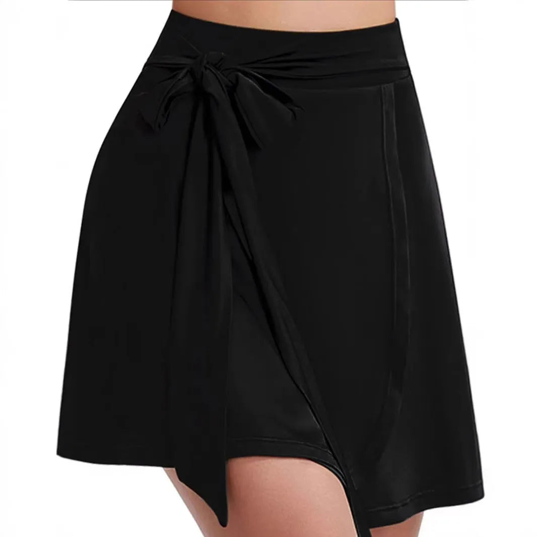 Black thigh-length culottes sports skirt with built-in shorts, high waist, and micro-elastic polyester fabric.