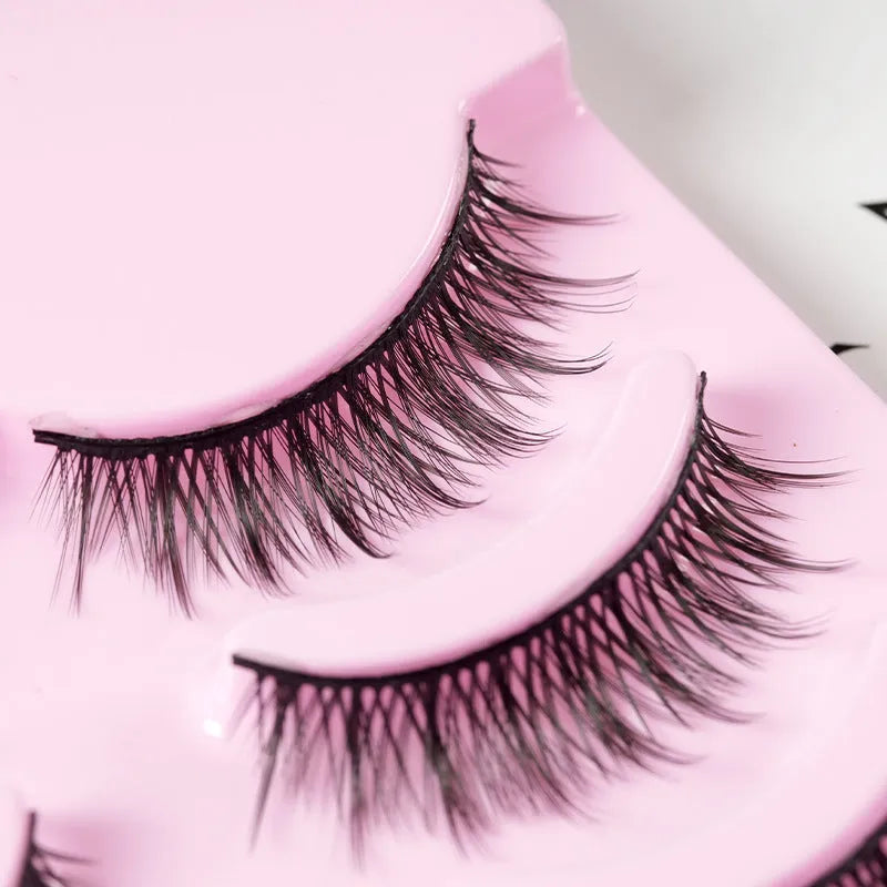 5 pairs of manga-style false eyelashes on a black strip, showing natural wispy Korean makeup look.