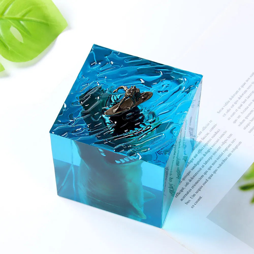 Epoxy resin shark surf scene night light ornament in 5cm and 8cm sizes on a table.