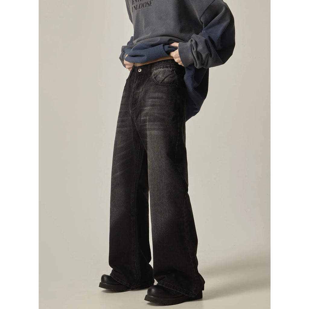 Black loose-fit straight-leg retro jeans with a zip fly on a neutral background.