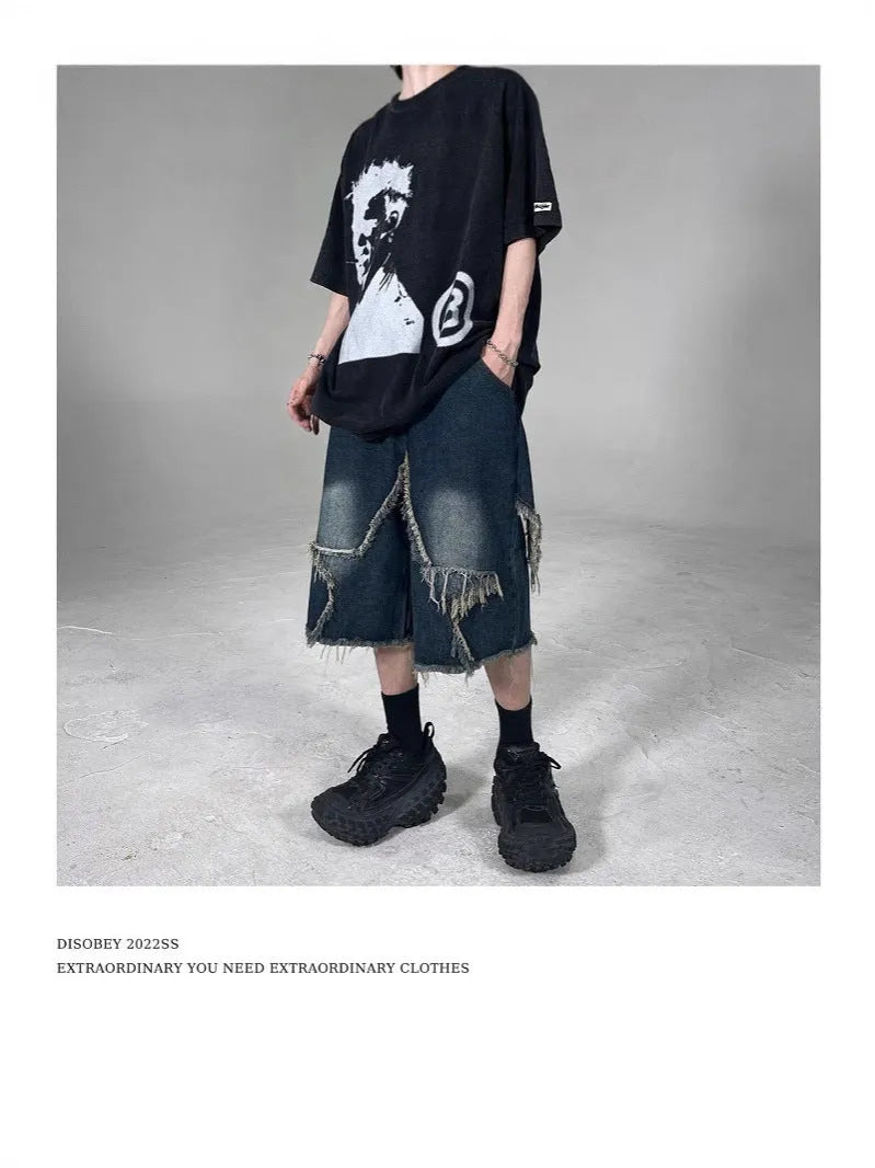 Blue denim shorts with a frayed five-pointed star detail on the leg, showing a loose, retro fit.