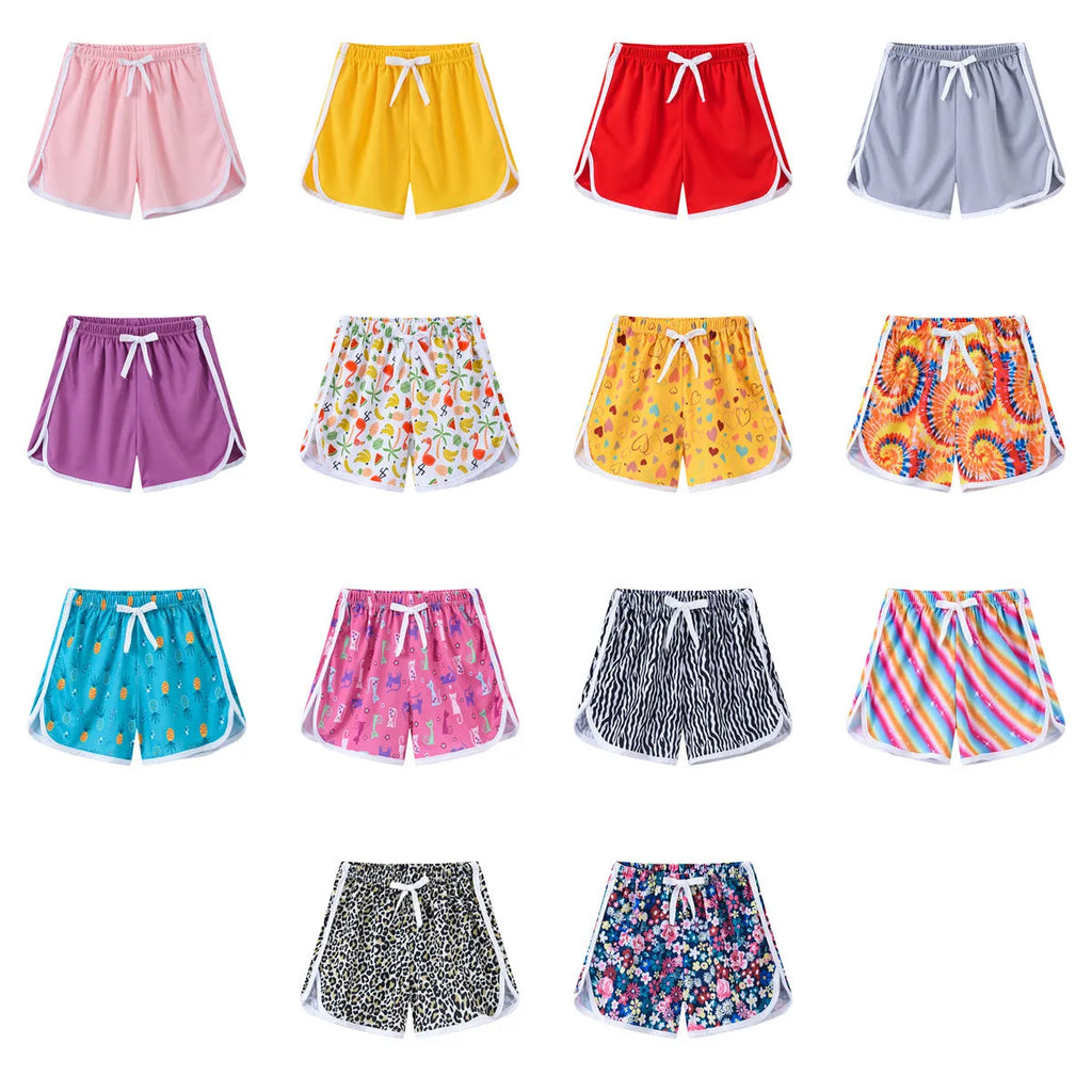 Children's casual beach shorts in polyester with multiple colour and pattern options for holiday wear