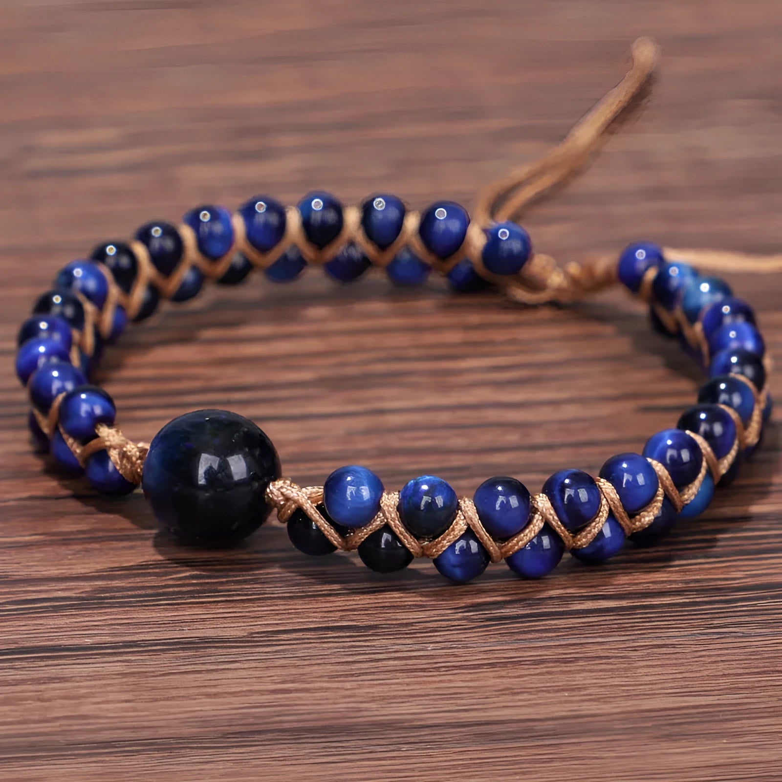 Hand-woven geometric bracelet made from tigereye stone with an adjustable sliding knot, shown in blue colour