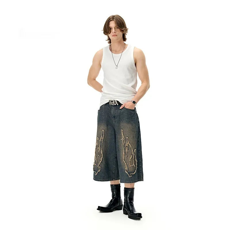 Men's black denim shorts with flame embroidery patch detail on straight leg casual cut