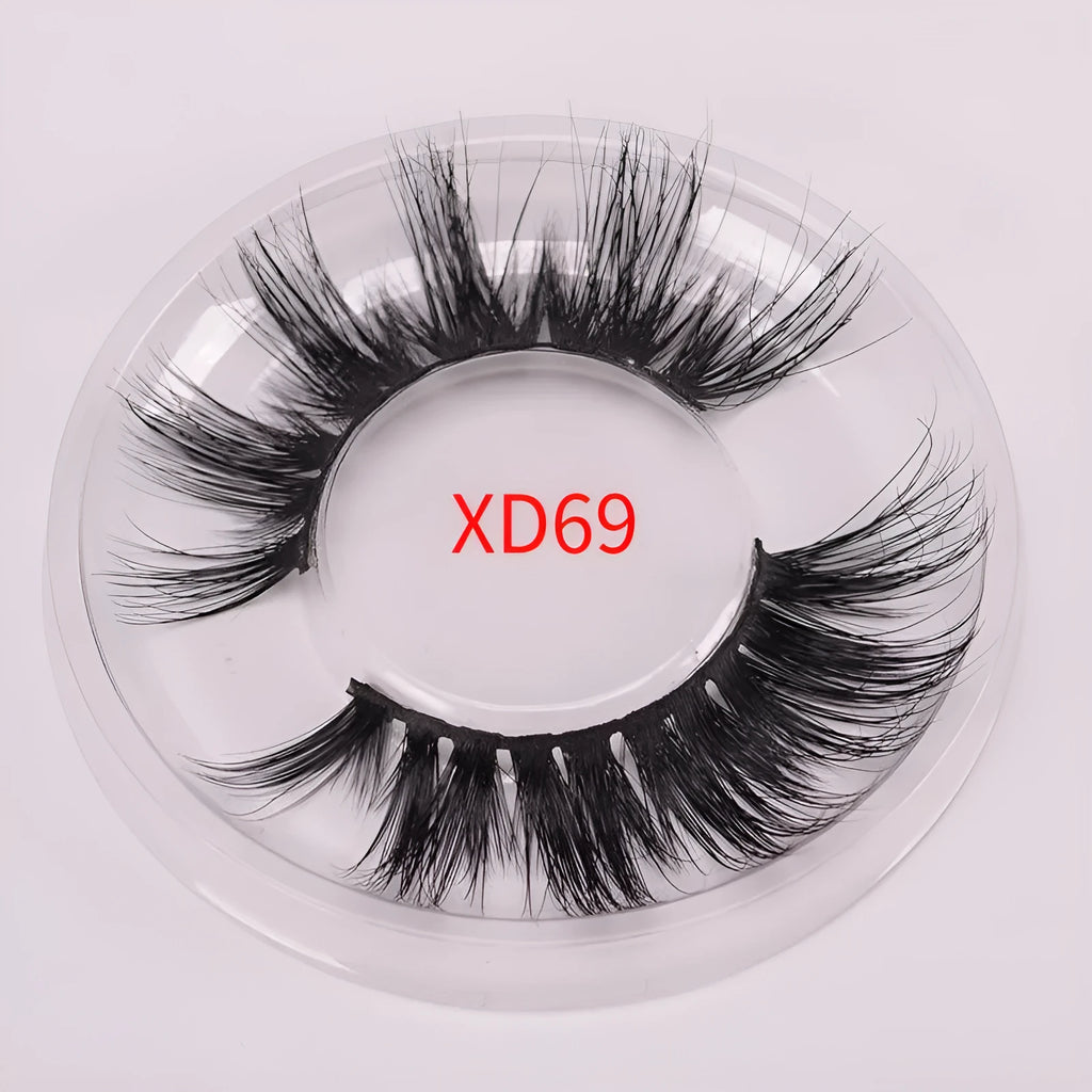 5D mink false eyelashes in natural black with curled ends, shown with double-headed glue brush and hair cap