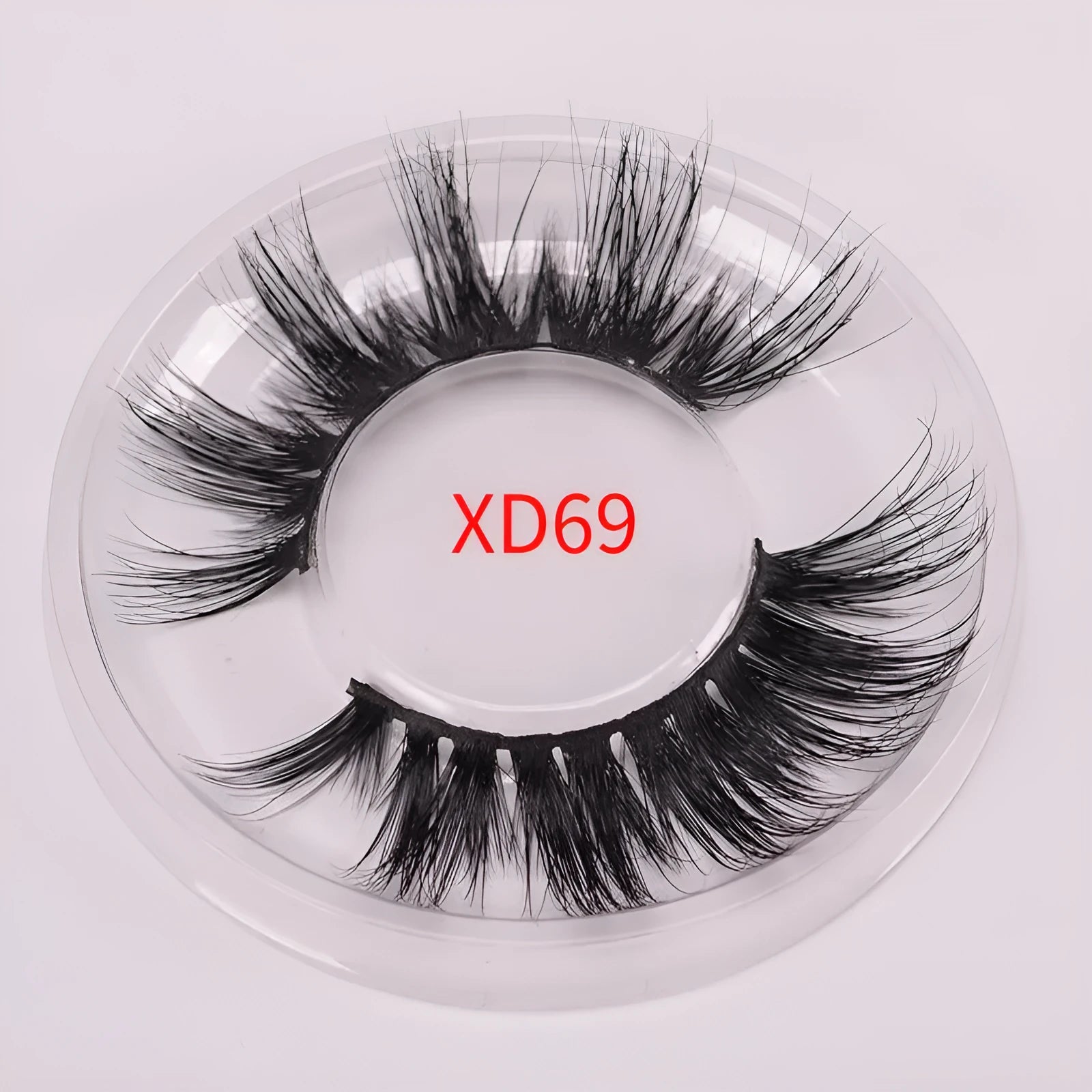 5D mink false eyelashes in natural black with curled ends, shown with double-headed glue brush and hair cap