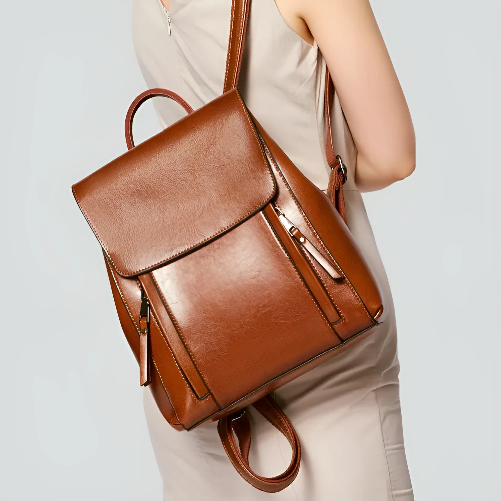Large black genuine leather women's backpack with multiple internal pockets and double shoulder straps.