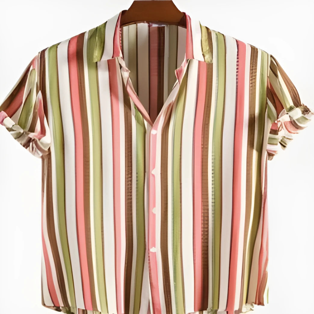 Man wearing a short-sleeved digital print shirt in a casual setting.