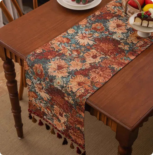 A retro style table flag with handwoven tassels in a blue ginkgo leaf pattern on a table.