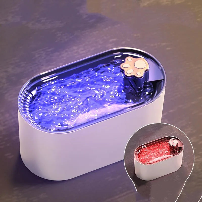 Blue automatic pet water fountain with filter on a floor next to a cat
