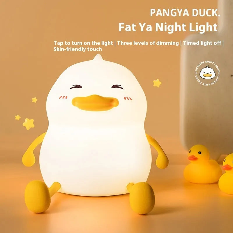 Chubby rechargeable touch-control night light with soft silicone phone holder base.