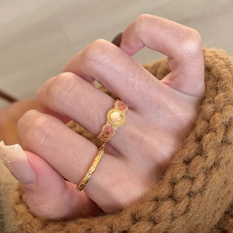 Geometric open mouth women's ring with pink crystal enamel on gold-plated copper.