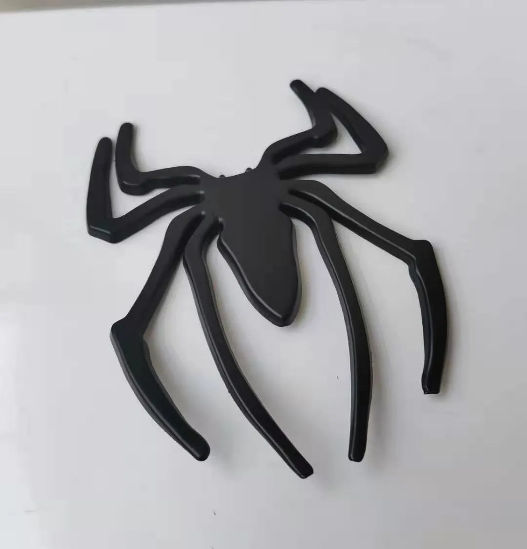 Gold 3D metal spider bumper sticker on a car bumper