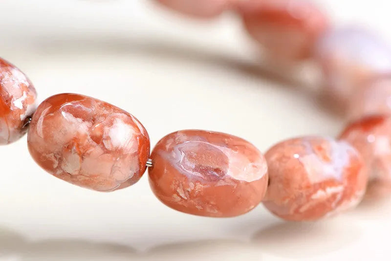 Natural cherry agate barrel bead bracelet with Ruyi pattern measuring 10x14mm