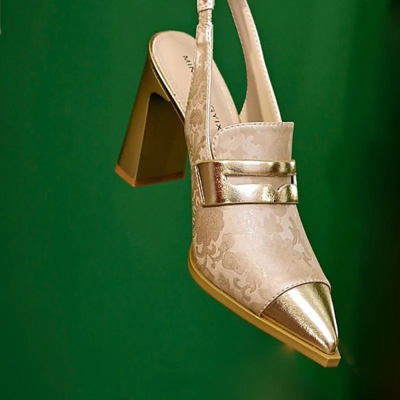 Women's black chunky heel high-cut sandals with pointed toe and elastic ankle strap.