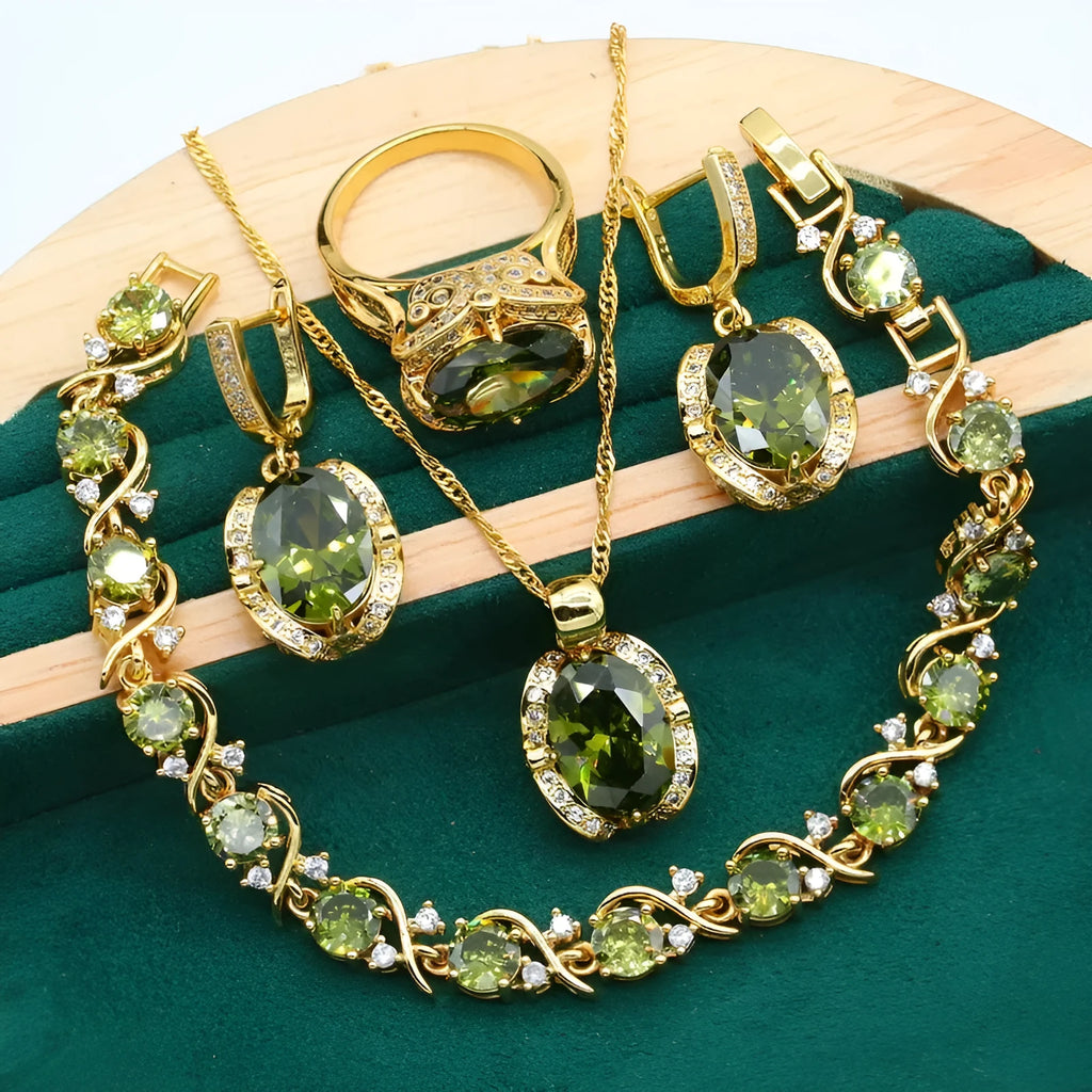 Olive green zircon rhinestone jewellery set on snake bone chain with crown pendant, plus matching earrings and ring.