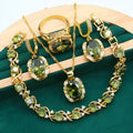 Olive green zircon rhinestone jewellery set on snake bone chain with crown pendant, plus matching earrings and ring.