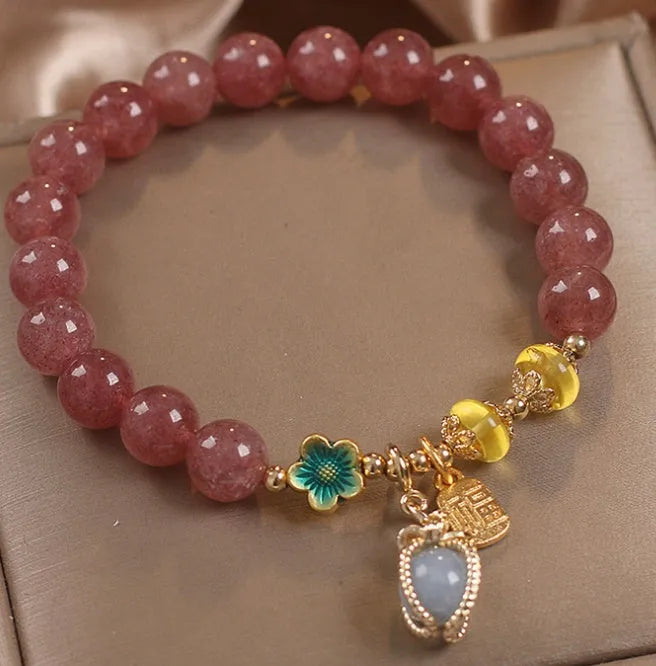 Red women's bracelet with natural strawberry quartz beads and rhinestone details on alloy setting