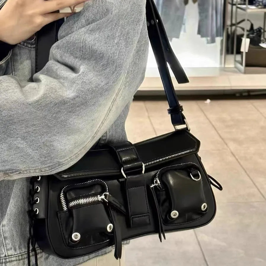Black PU leather underarm baguette bag with an adjustable long strap.