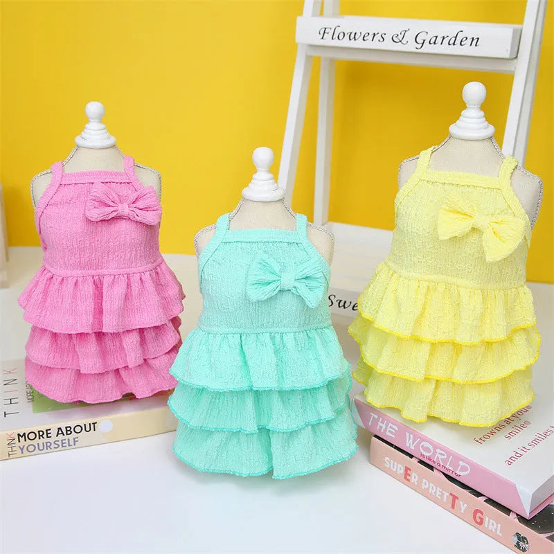 Small dog wearing princess dress with layered skirt design in candy colour option