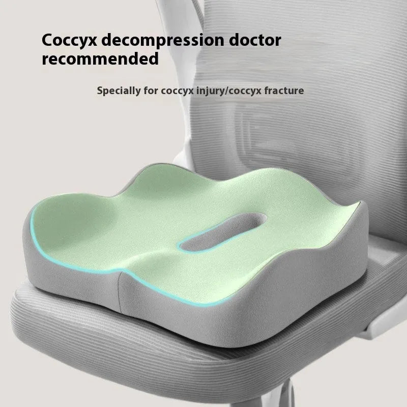 A solid colour memory foam seat cushion for lumbar support, shown in a grey colour option on an office chair.