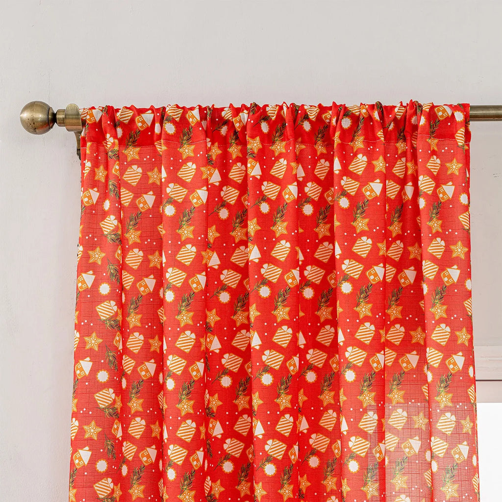 Green festive curtain with printed cartoon snowman and angel pattern.