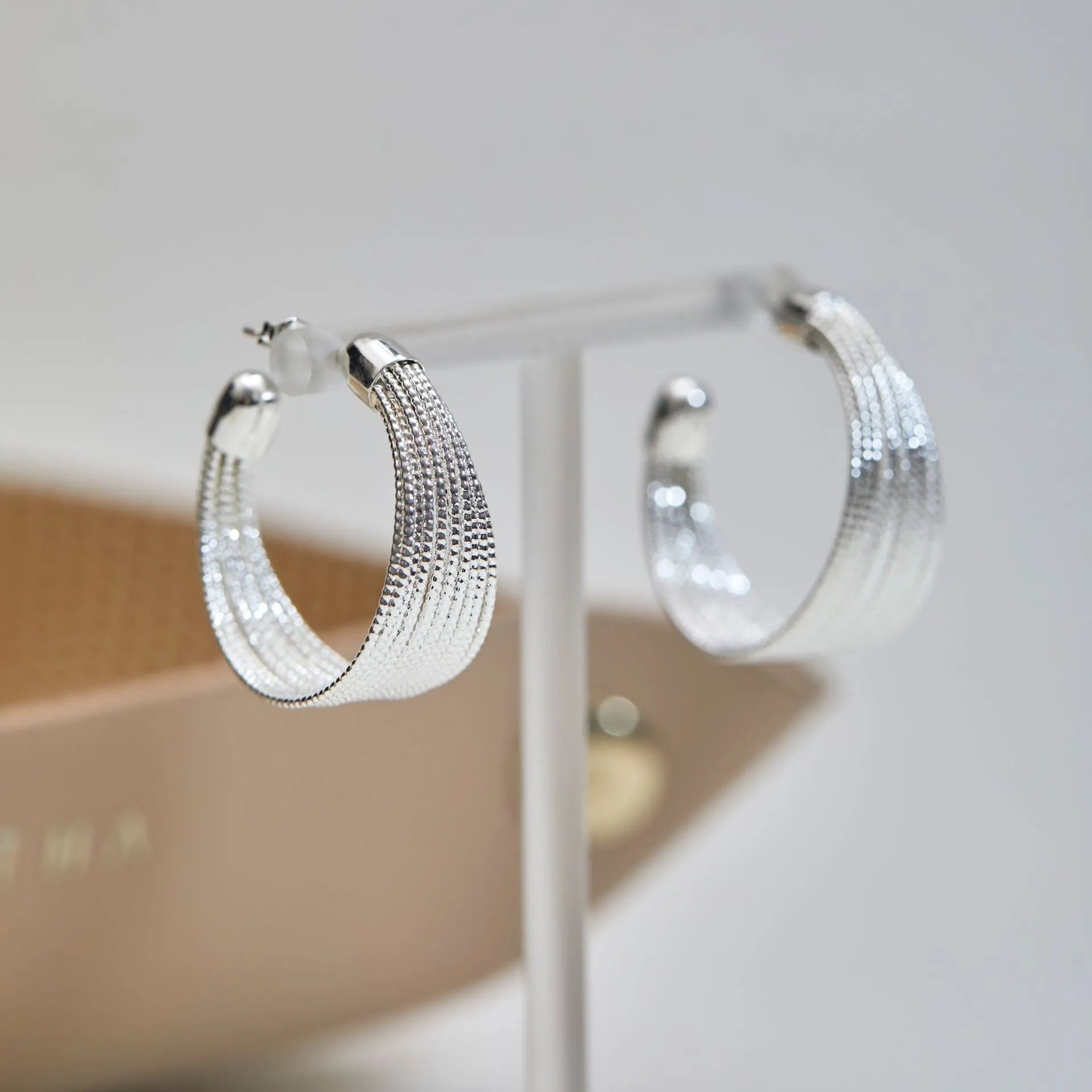 Geometric copper earrings with electroplated silver and gold finishes including stud and clip styles