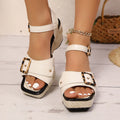 Women's black chunky heel sandals with a square toe and metal button buckle closure on a rubber sole.