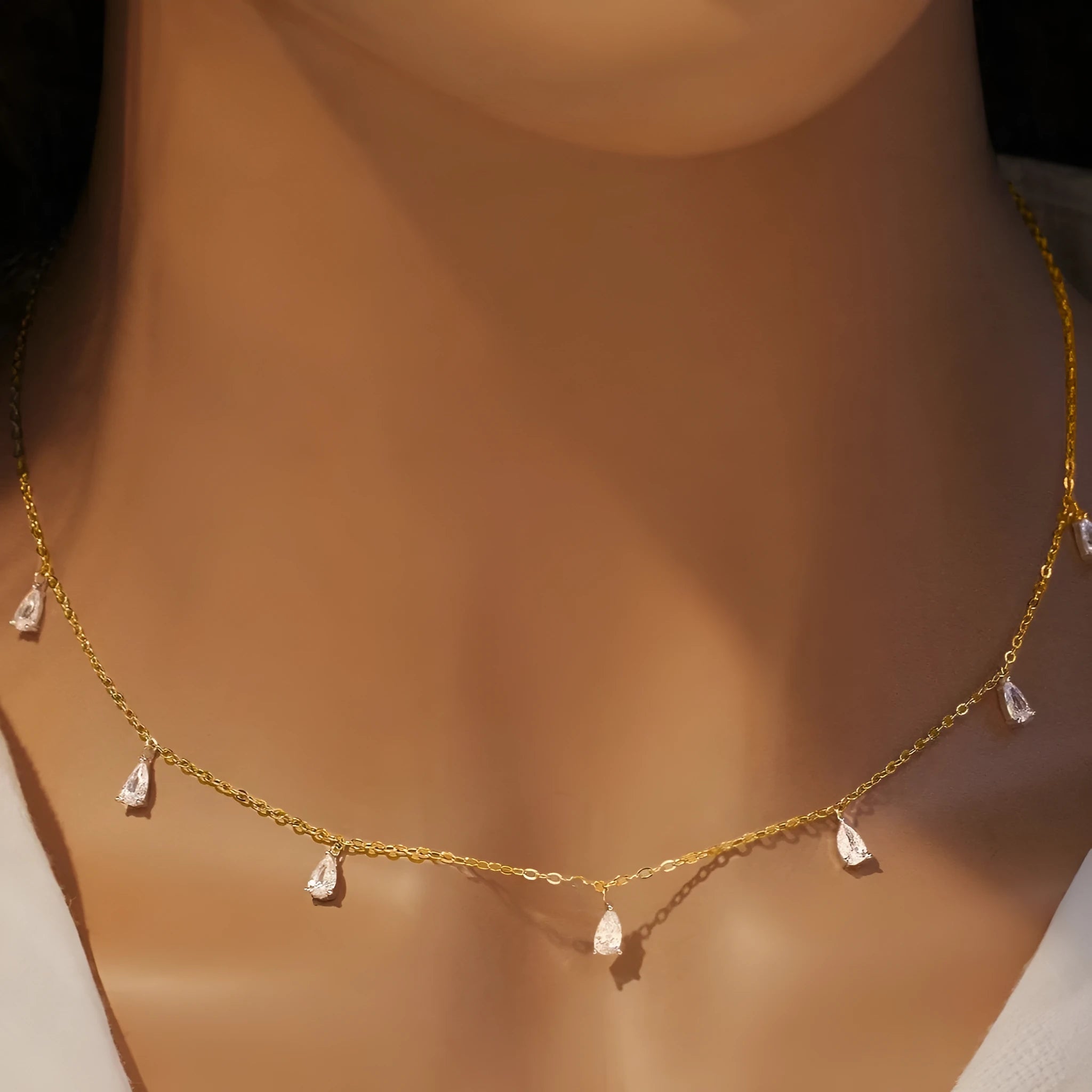 Sterling silver necklace with drop-shaped artificial zircon pendant on adjustable chain in silver, rose gold, and golden yellow finishes