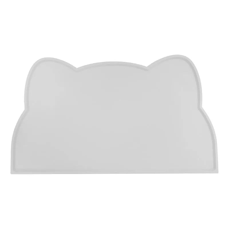 Blue silicone pet feeding mat with cat head design under food and water bowls