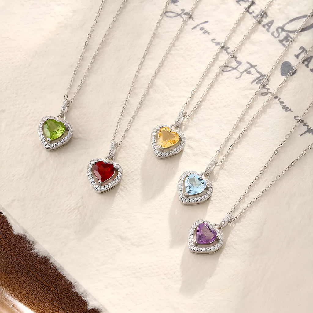 Sterling silver heart necklace with a natural amethyst gemstone on a cross chain.