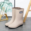 Women's mid-calf PVC rain boots in black with low heel for waterproof work footwear