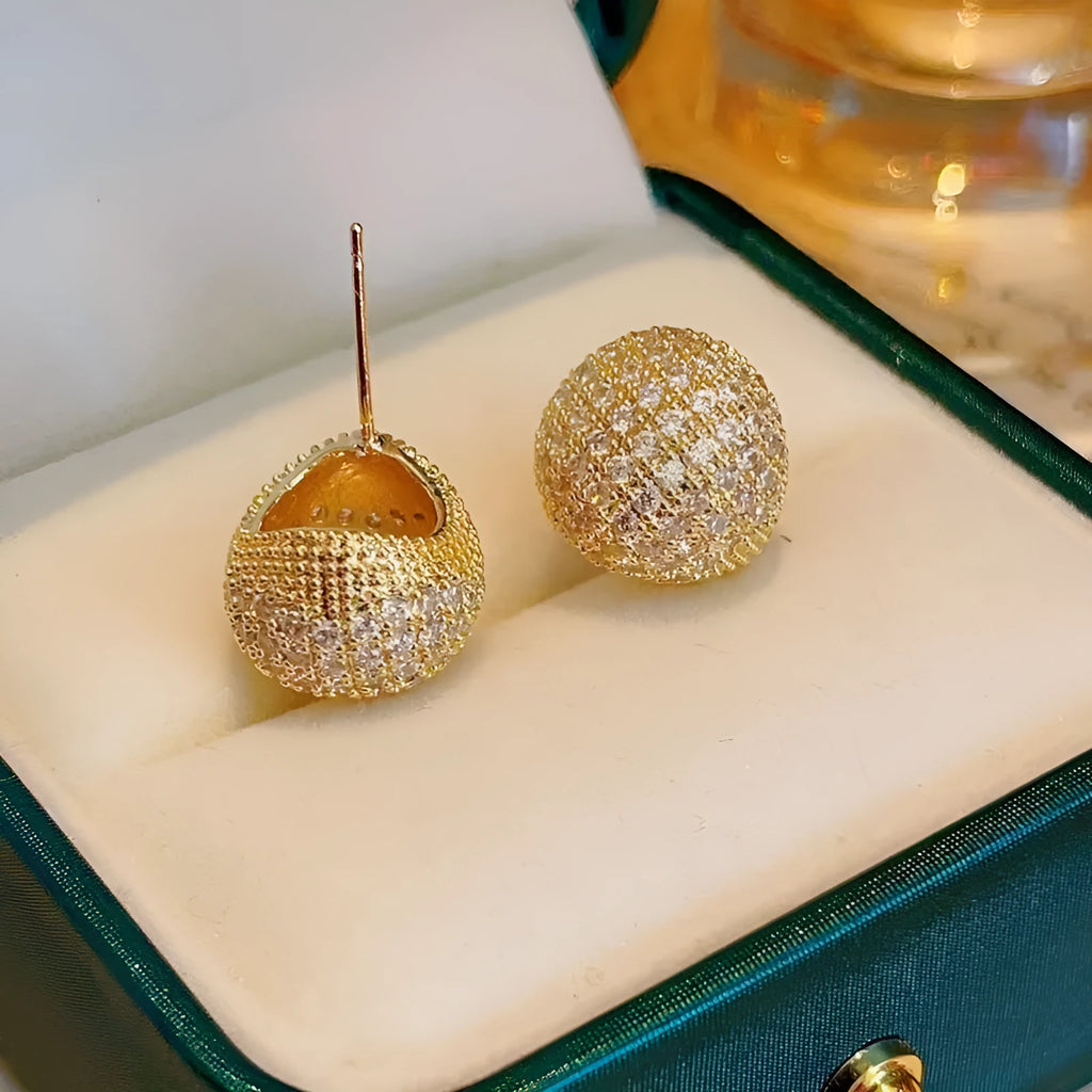 Golden beans drop-shaped earrings with full diamond embellishment and geometric design